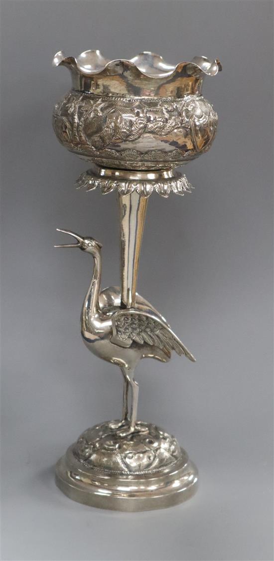 An Indian embossed white metal vase, with stork stem, 23.8cm.